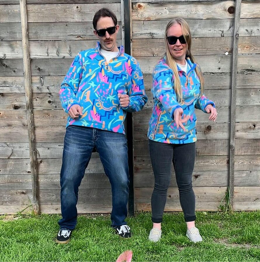 A couple playing Disc GO! in matching neon pullovers